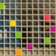 Colorful glass brick wall with a geometric pattern featuring various bright shades and abstract design elements.